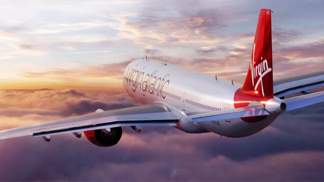 Virgin Atlantic aircraft parked at a London airport terminal, representing premium international travel and flight deals.