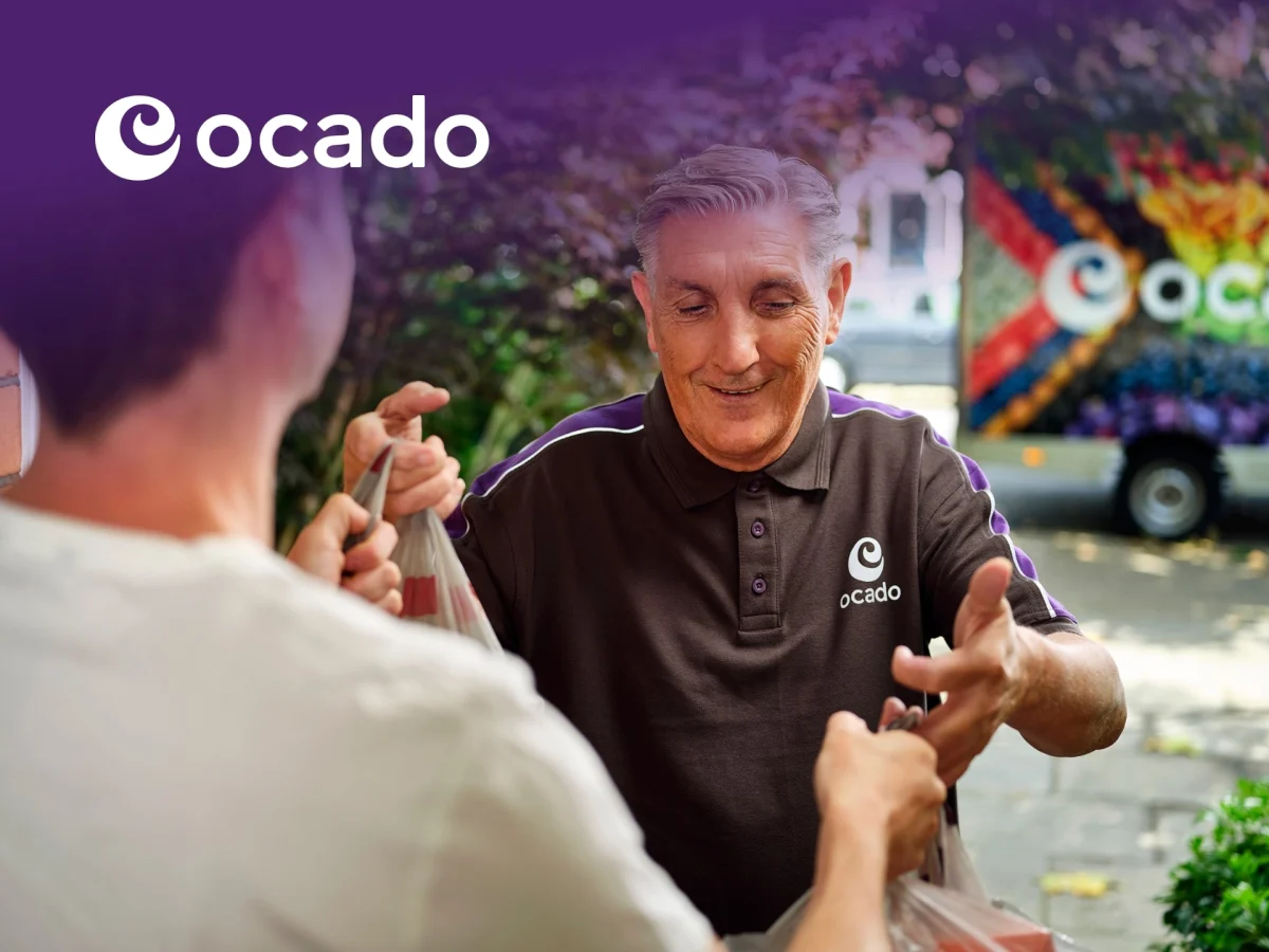 Ocado online grocery shopping delivery service with fresh food items on a kitchen counter in the UK.