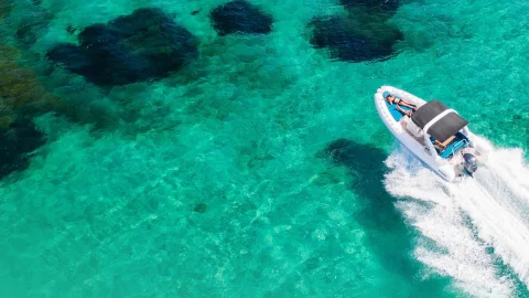 A luxury yacht sailing on turquoise waters, representing Click&Boat yacht charter deals and boat rental services.