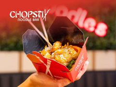 Close-up of chopsticks on a dark background, Asian cuisine, food photography, elegant dinner, dining utensils, chopstick set.