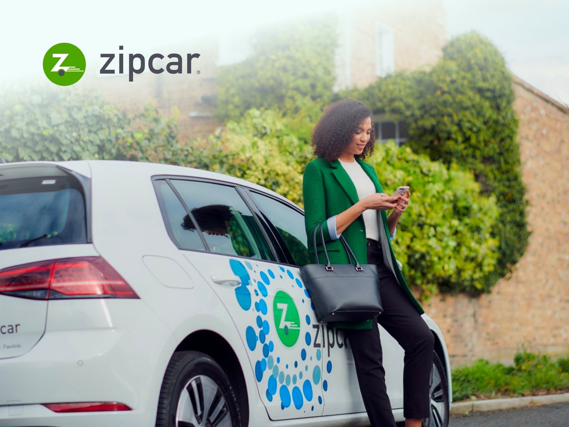 Zipcar Promo Code Zipcar car parked in a city street. Shared car service, car sharing, urban transportation, eco-friendly commute.