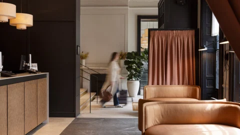 Luxury hotel bedroom at Apex Hotels featuring modern decor, plush bedding, and a bright, welcoming atmosphere.