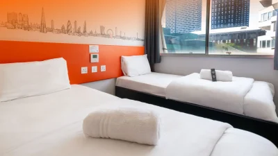 Modern easyHotel exterior featuring bright branding, representing affordable budget accommodation in the UK.