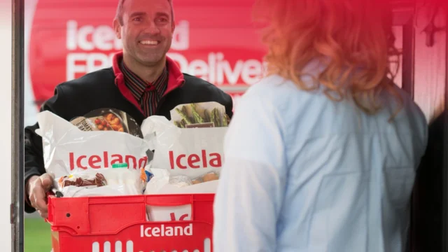Iceland Groceries store front with bright signage, promoting affordable food deals and frozen meal savings.