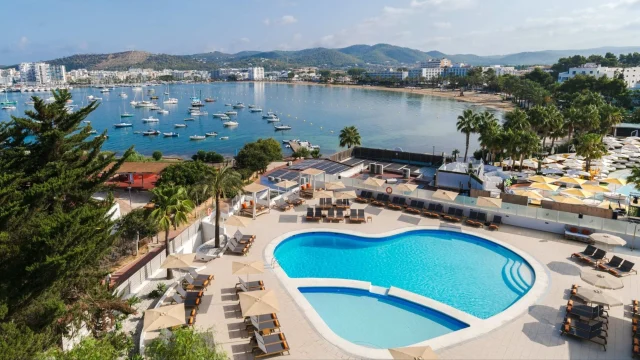 Luxury THB Hotels resort exterior with swimming pool and sun loungers under a clear blue sky for holiday bookings.