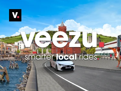 Veezu private hire taxi service branding displayed on a professional vehicle for local transport and travel.