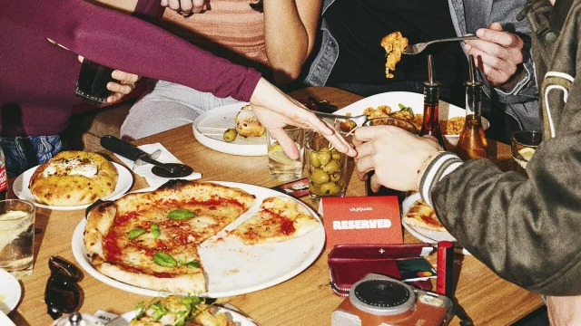 Vapiano restaurant interior featuring fresh pasta dishes and a vibrant, modern dining atmosphere for customers.