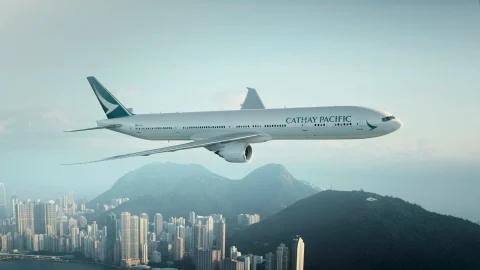Cathay Pacific aircraft exterior view at an international airport terminal for premium travel and flight bookings.