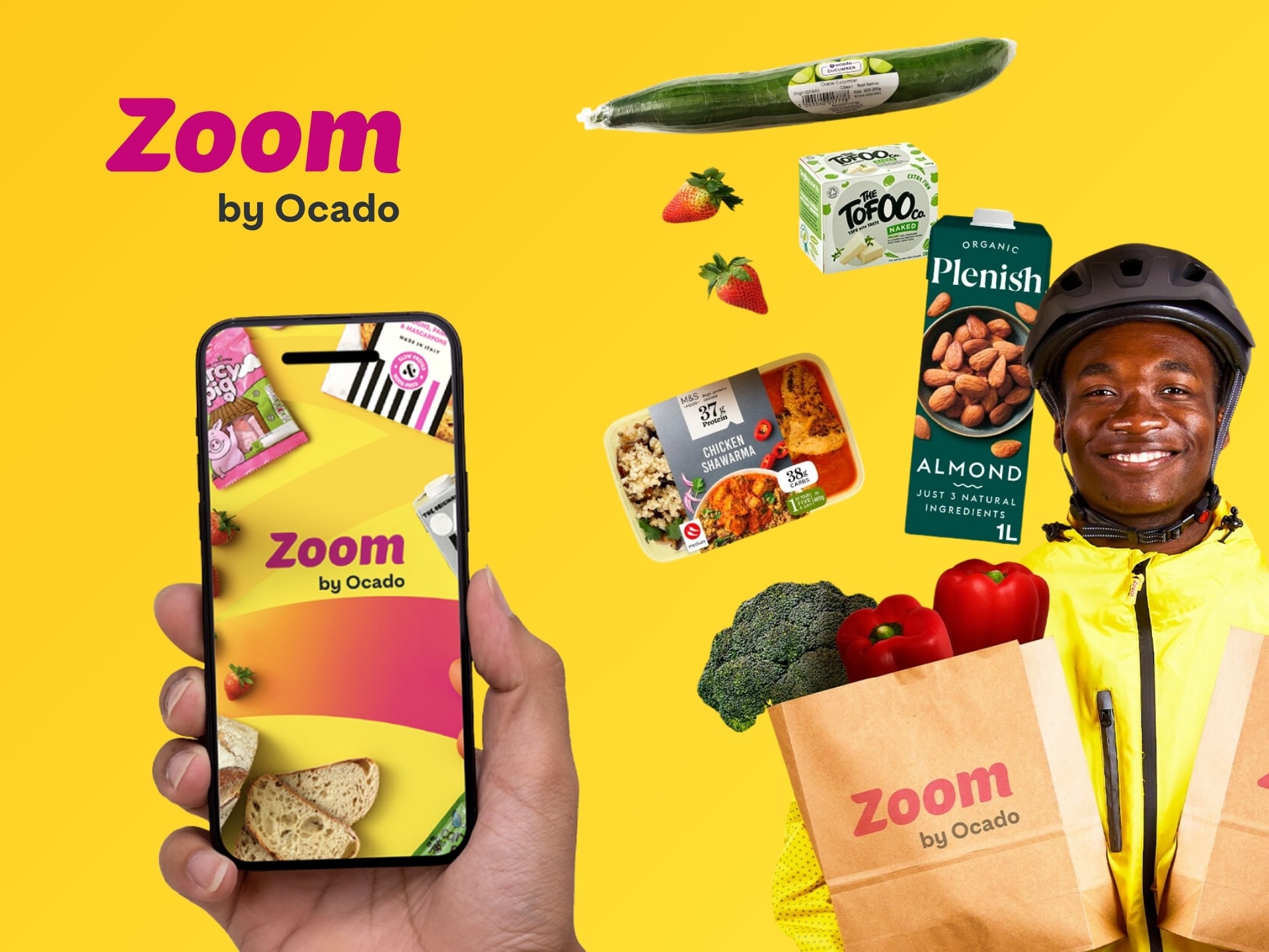 Zoom by Ocado bike delivery courier holding grocery bag with smartphone app