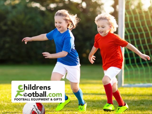 Children playing football on a sunny field. Kids football drills and training for youth at ChildrensFootball.com.