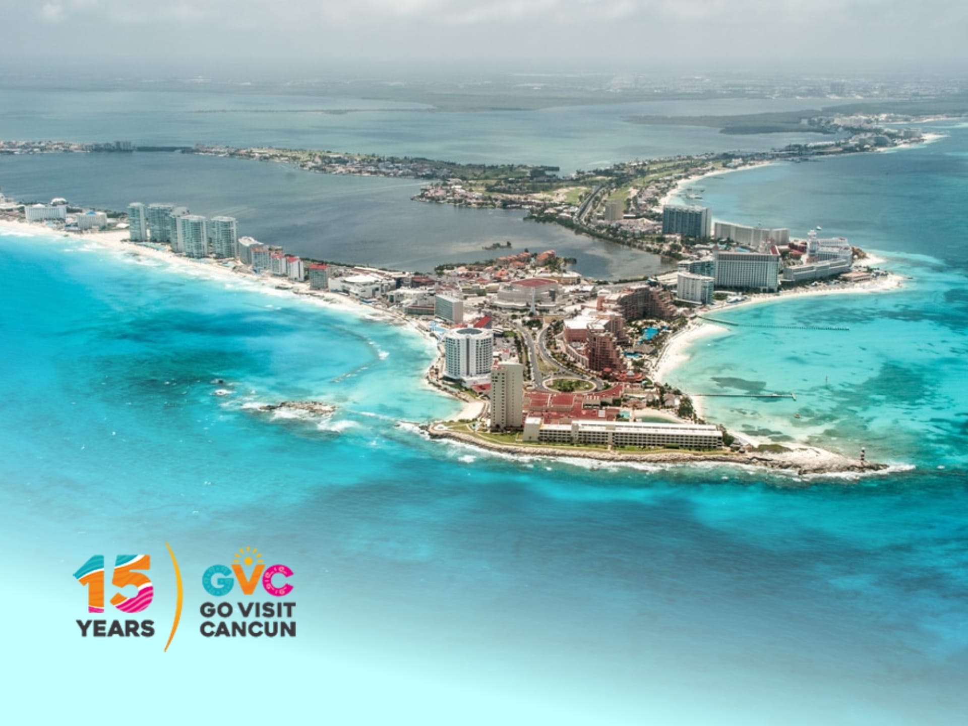 Go Visit Cancun Promo Code Cancun, Mexico travel destination: turquoise water, white sand beach, and resort hotels under a blue sky. Visit Cancun for vacation deals.
