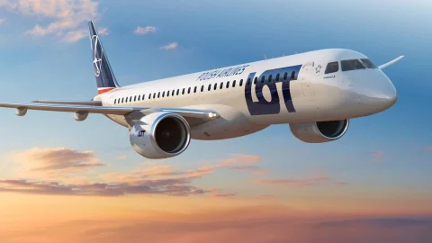LOT Polish Airlines passenger aircraft cruising above the clouds during a flight, showcasing the airline's livery.