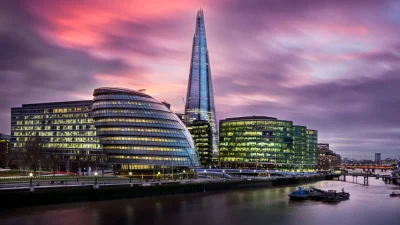 Panoramic view of the London skyline from The Shard observation deck at sunset, showcasing iconic city landmarks.