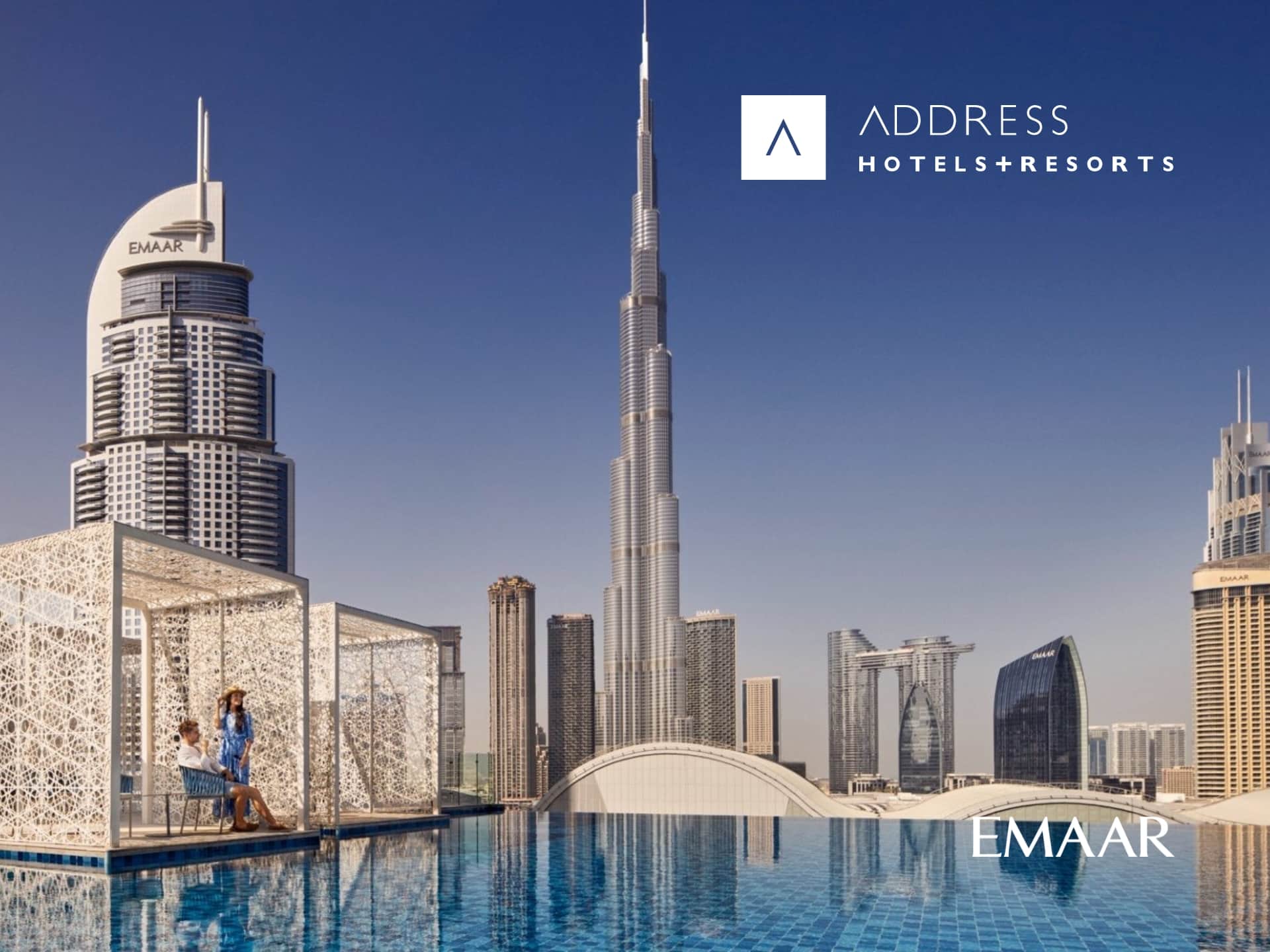 Address Hotels & Resorts: Luxury hotel exterior at dusk, showcasing modern architecture and inviting ambiance. Perfect for a relaxing getaway.