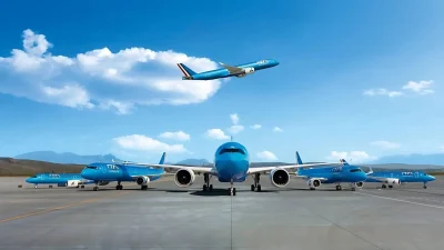 ITA Airways passenger aircraft parked at an airport terminal, showcasing the airline's modern blue livery and branding.