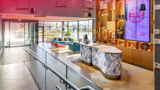 Luxury Millennium Hotels exterior view featuring modern architecture and elegant entrance for guest bookings.