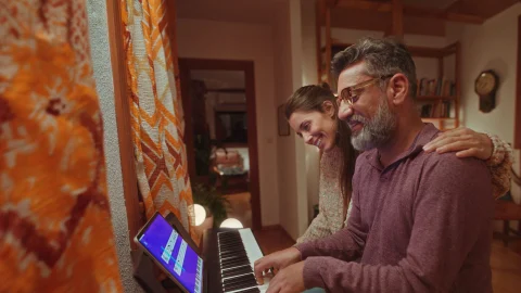 A person using the Simply Piano app on a tablet to learn piano, showcasing an easy and effective music learning method.