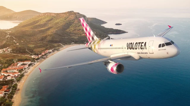 Volotea Airlines passenger aircraft parked at an airport terminal, representing budget travel and flight deals.