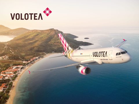 Volotea Volotea aircraft flying over a sunny landscape. Cheap flights and travel deals from Volotea. Book your next adventure!