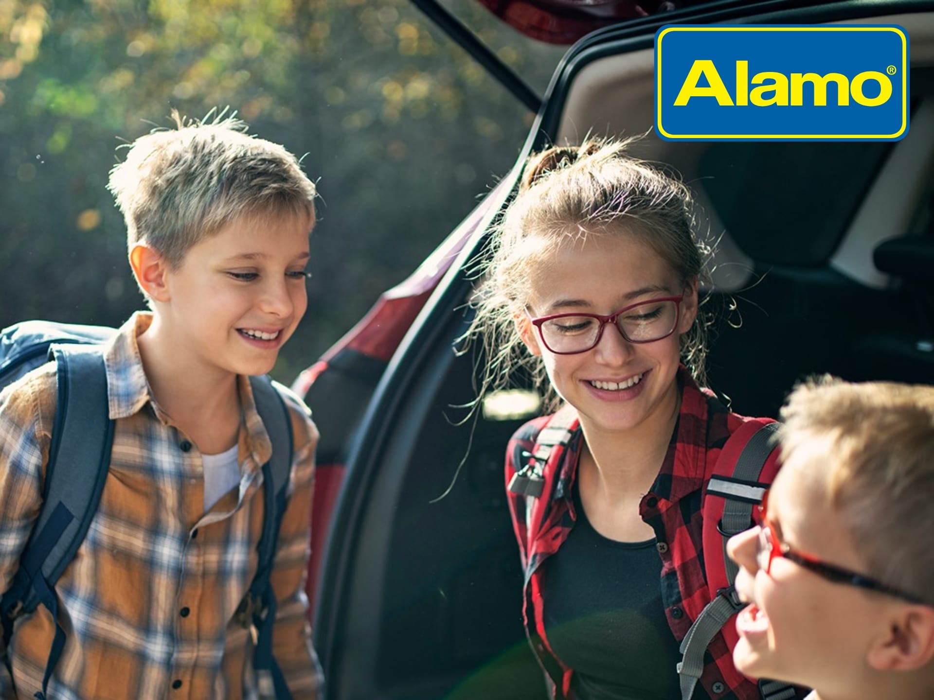 Alamo UK Discount Code Alamo UK car rental cover image featuring a family and a rental car, highlighting deals and savings on UK car hire.