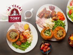 Toby Carvery restaurant exterior with a sunny sky, showcasing their famous roast dinner and carvery experience. Great for a family meal.