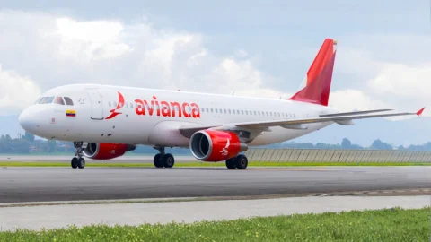 Avianca Airlines aircraft flying above the clouds, representing premium travel and flight booking deals.