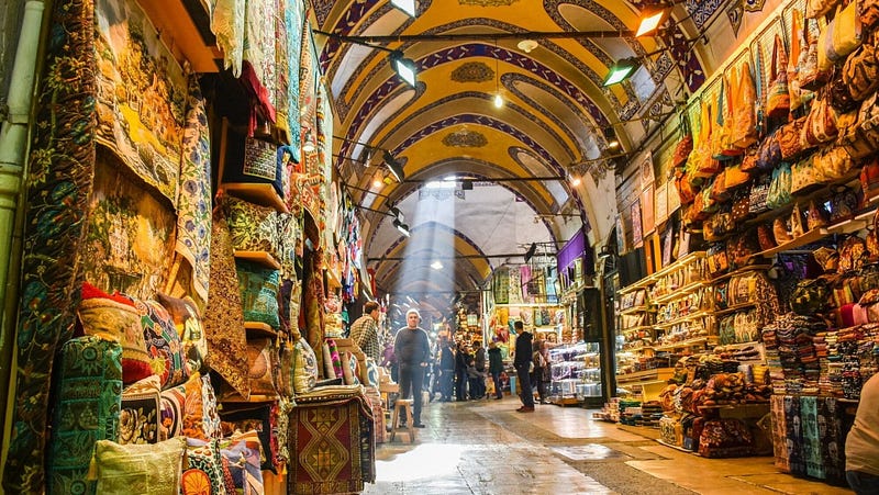 Scenic view of Cappadocia's fairy chimneys at sunrise, Türkiye. Unique geological formations, hot air balloons (blurred), travel guide, hidden gems.