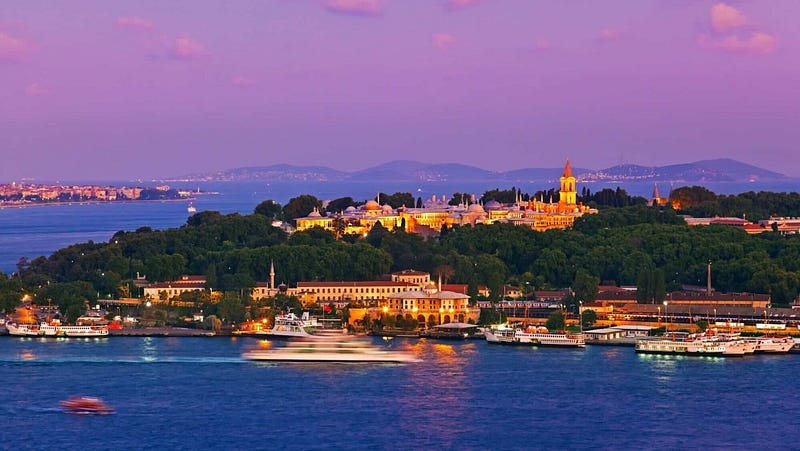 Scenic view of Cappadocia, Turkey with hot air balloons at sunrise, showcasing the unique landscape and cave dwellings. Travel guide for Türkiye.