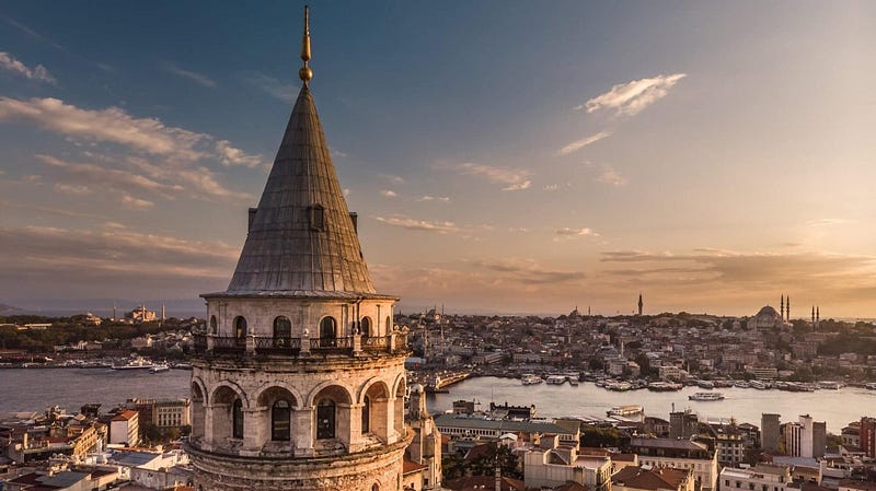 Scenic view of Cappadocia, Turkey with fairy chimneys and hot air balloons at sunrise. Travel guide for Türkiye.