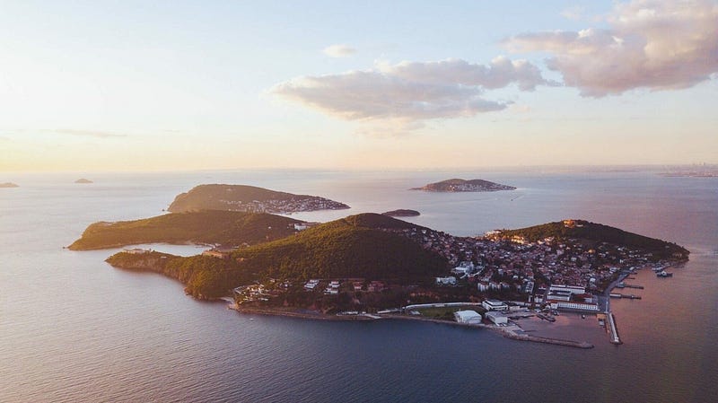Cappadocia, Turkey: Hot air balloons at sunrise over fairy chimneys. Turkish travel guide for hidden gems. #Cappadocia #Turkey #Travel #HotAirBalloons