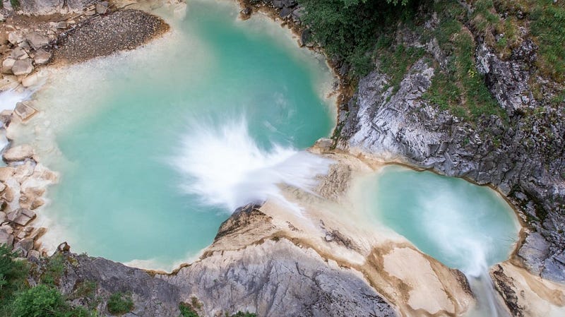 Scenic view of Cappadocia, Turkey with hot air balloons rising at sunrise, showcasing the unique fairy chimneys. Travel guide, Türkiye tourism, hidden gems, Turkish landscape, sunrise view.