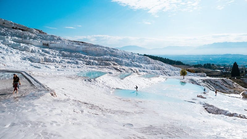 Scenic view of Cappadocia, Turkey with hot air balloons at sunrise. Unique landscape, fairy chimneys, travel guide, hidden gems, Türkiye tourism.