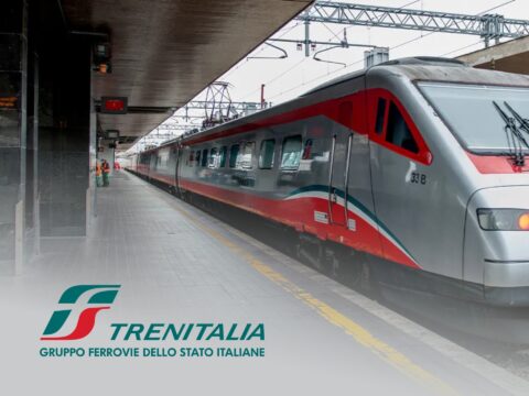 Red high-speed Trenitalia Frecciarossa train in Italy, highlighting rail travel deals and ticket savings.