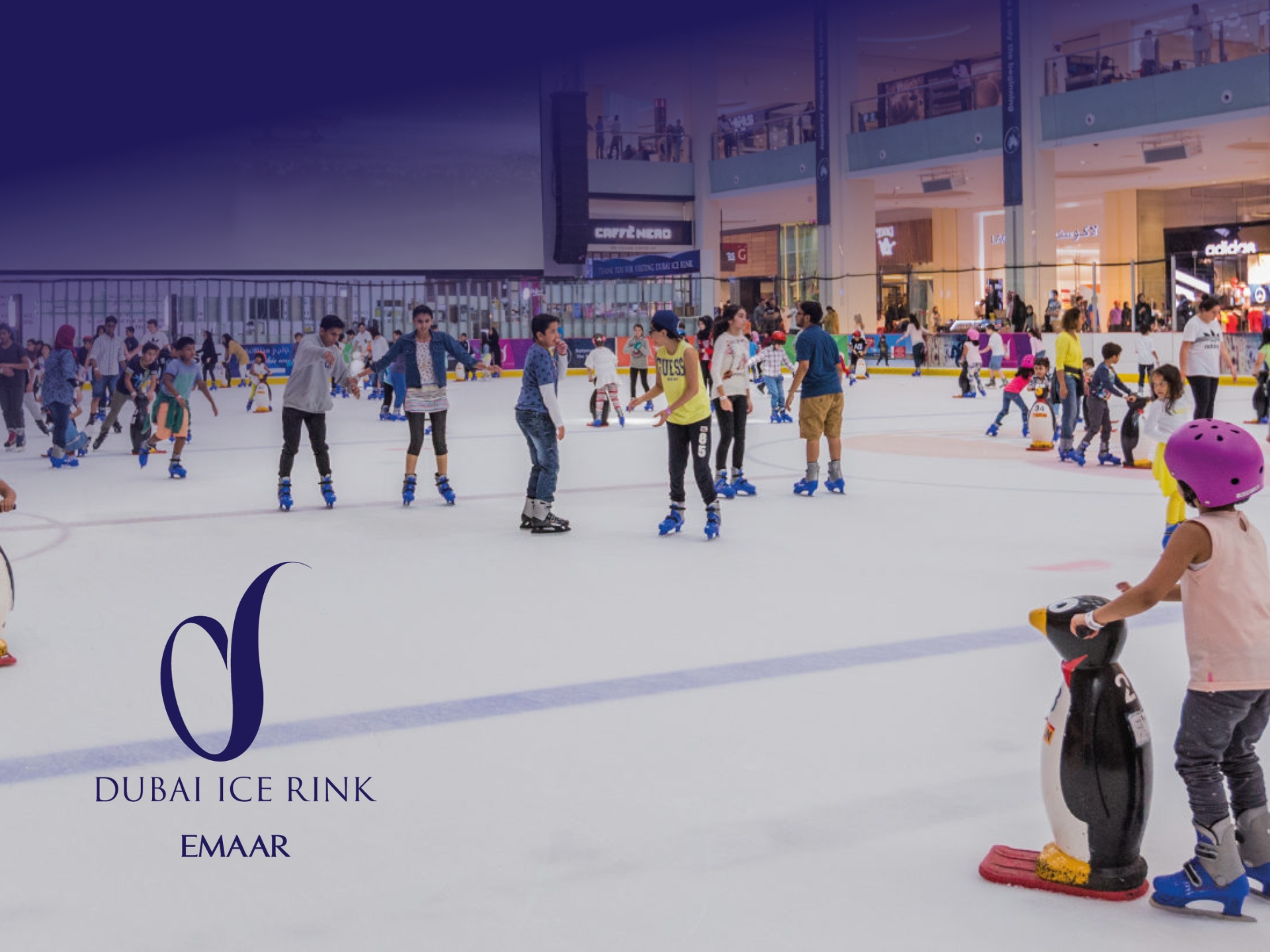 Skaters at the Olympic-sized Dubai Ice Rink in The Dubai Mall, a premier indoor leisure attraction by Emaar.