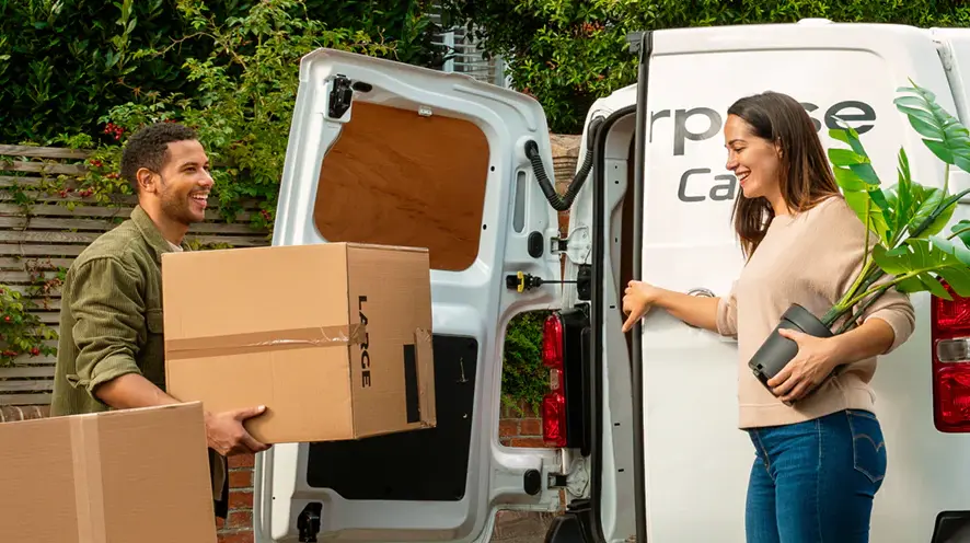 Unloading moving boxes from the back of an Enterprise Car Club utility van