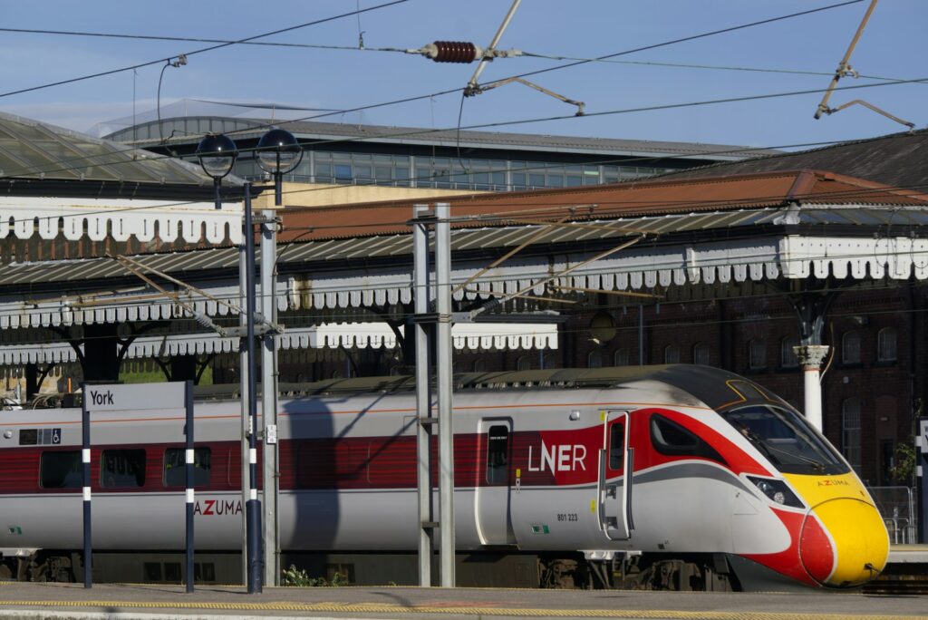 LNER Class 801 Azuma train at York station platform on the Edinburgh to London rail route.