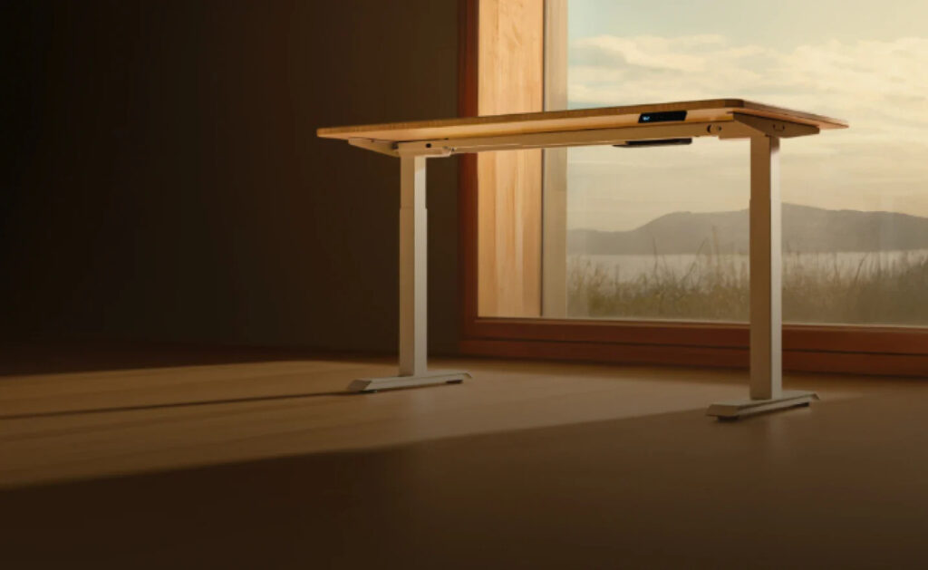 Desktronic electric standing desk in a modern UK home office setup, perfect for remote work and ergonomics.