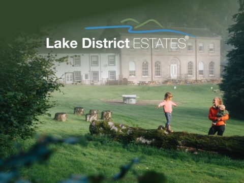 Scenic landscape of Lake District Estates properties and rolling hills in the Cumbrian countryside.