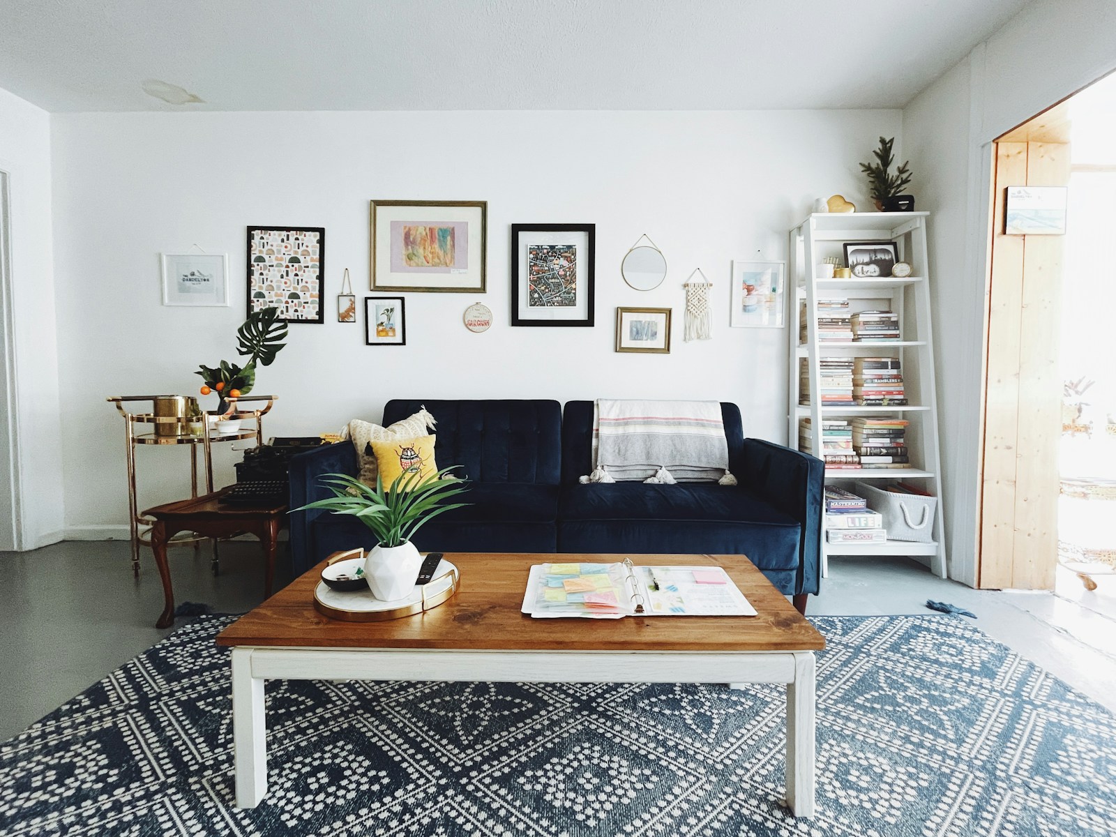 Chic living room with navy velvet sofa and gallery wall art