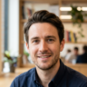 Professional portrait of Jake, a smiling man. Ideal for business profiles, team pages, or personal branding.