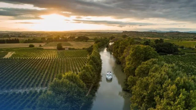 Le Boat luxury canal boat cruising along a scenic European waterway during a summer holiday getaway.