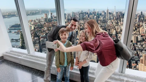 Panoramic view of the New York City skyline from the One World Observatory observation deck at sunset.