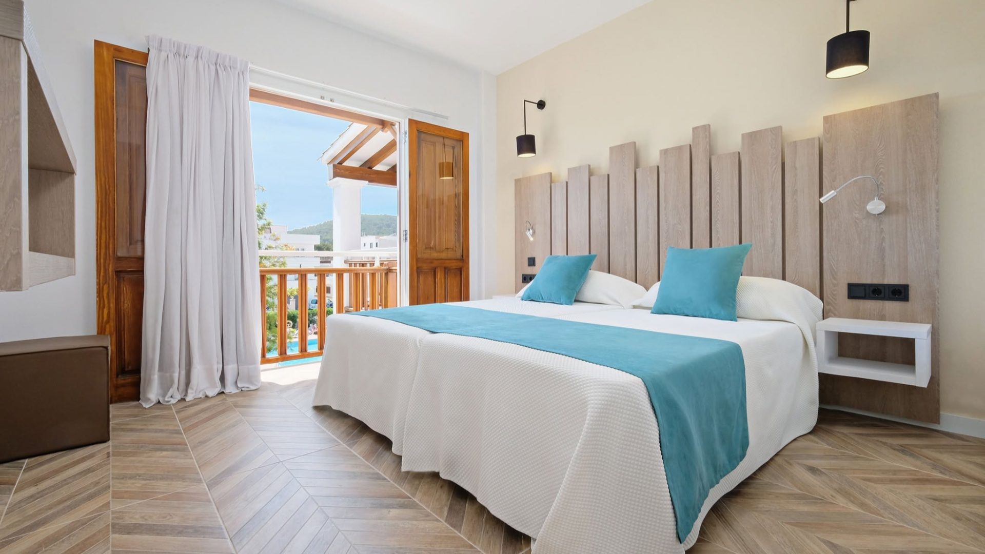 AzuLinehotels luxury resort exterior view featuring a swimming pool and sun loungers for a relaxing summer holiday.