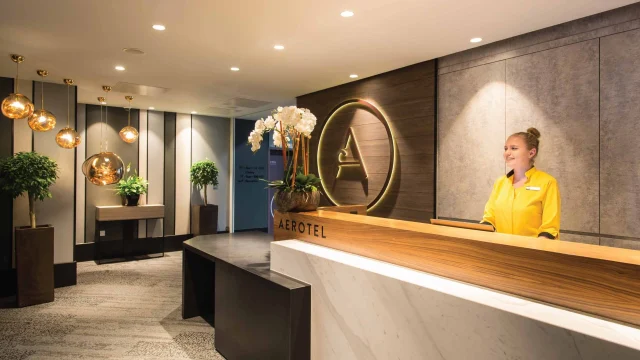 Modern Aerotel airport hotel room interior featuring a comfortable bed, minimalist design, and relaxing ambience.