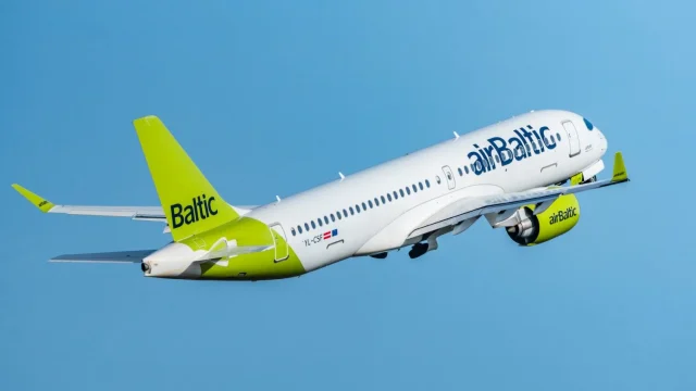 An airBaltic aircraft parked at the airport terminal, representing affordable European air travel and flight deals.