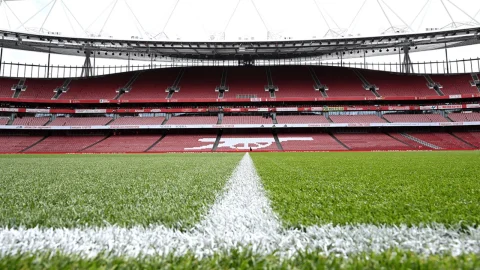 View of the Emirates Stadium pitch during an official Arsenal Stadium Tour in North London for football fans.