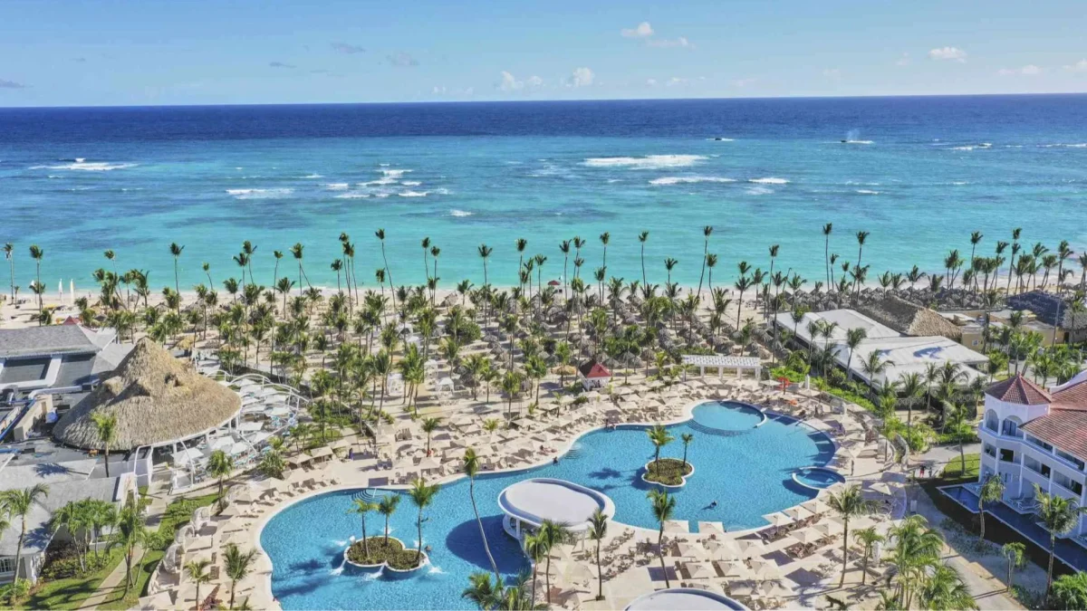 Aerial view of the Bahia Principe luxury resort featuring tropical gardens, swimming pools, and a pristine sandy beach.