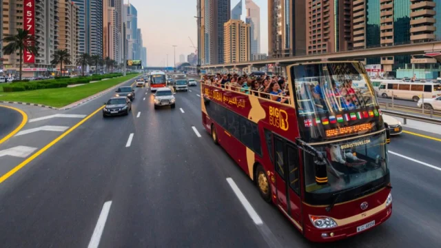 A red open-top Big Bus Tours vehicle travelling through a historic city centre, perfect for sightseeing and city breaks.