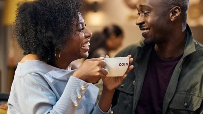 Costa Coffee branded storefront with inviting seating area for customers to enjoy premium coffee and snacks.