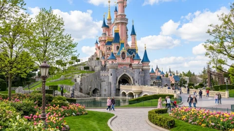 Family posing in front of Sleeping Beauty Castle at Disneyland Paris, perfect for planning a UK family holiday.
